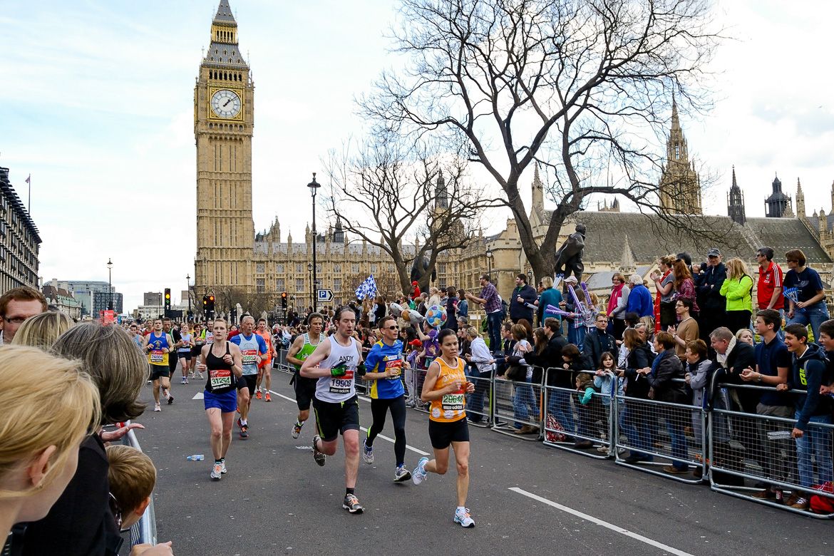 London United Kingdom - April 22 2012: Runners participating in the London Marathon 2012 passing The Houses of Parliament and Big Ben